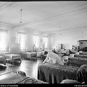 A girl making a bed in a dormitory at the Home of the Good Shepherd girls home, Ashfield